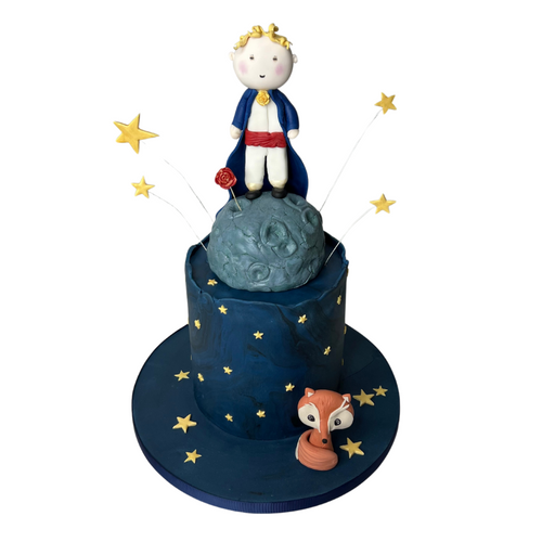 Hand-sculpted Little Prince and fox cake with blue night-sky tiers decorated with stars, crafted in organic sponge and chocolate ganache.