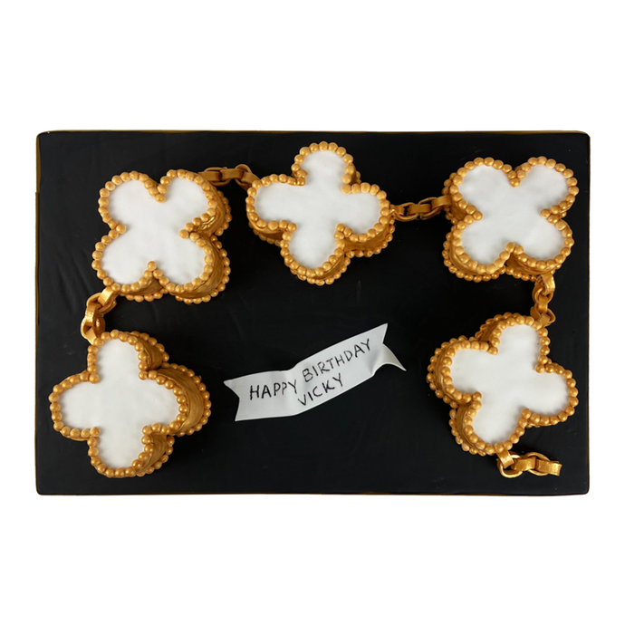 Hand-sculpted luxury Alhambra clover bracelet cake with mother-of-pearl and gold detailing from Bal Cakery, London.