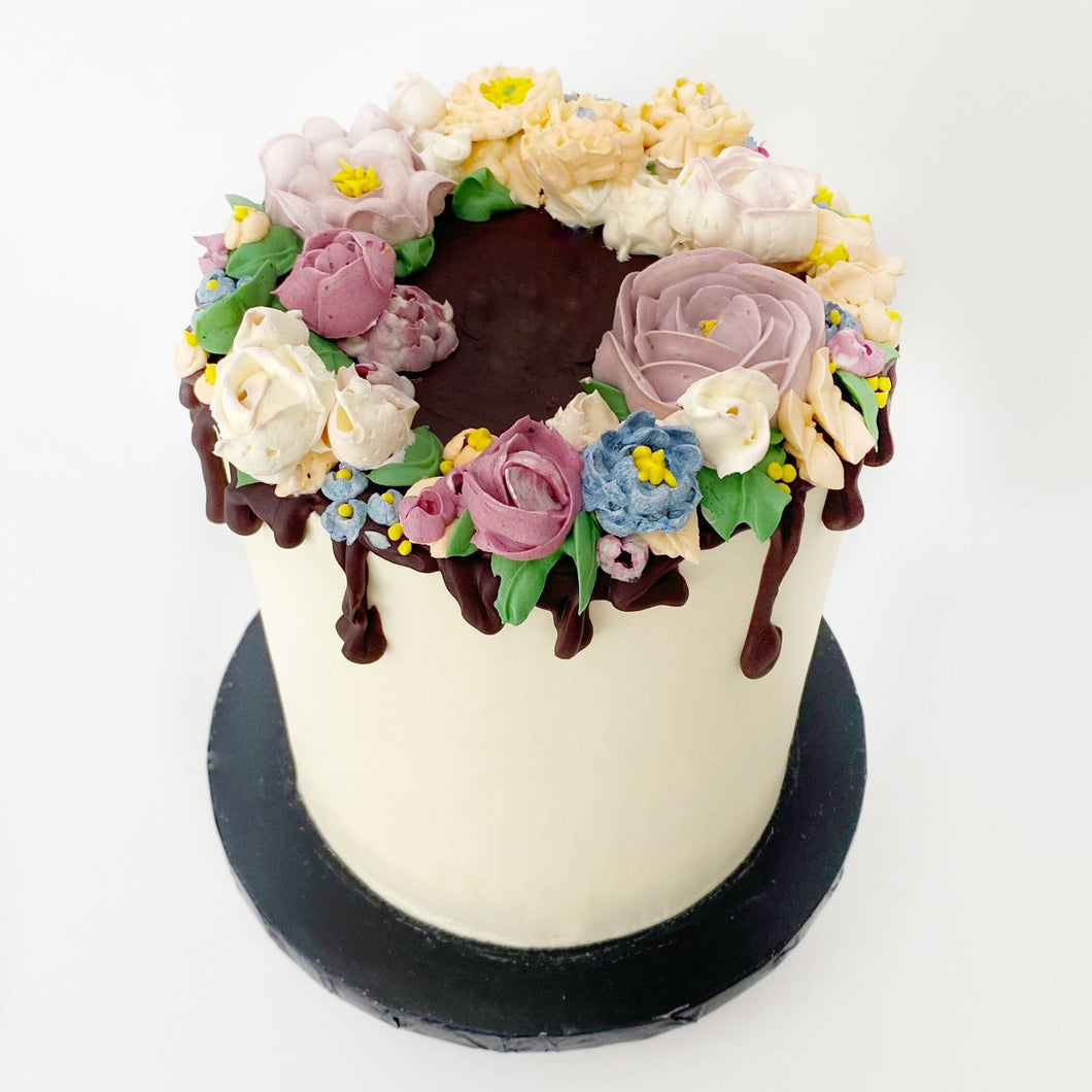 Colourful piped buttercream flowers. Perfect edible gifting idea for your special person. Order your birthday cake now. Delivery is available in and around London.